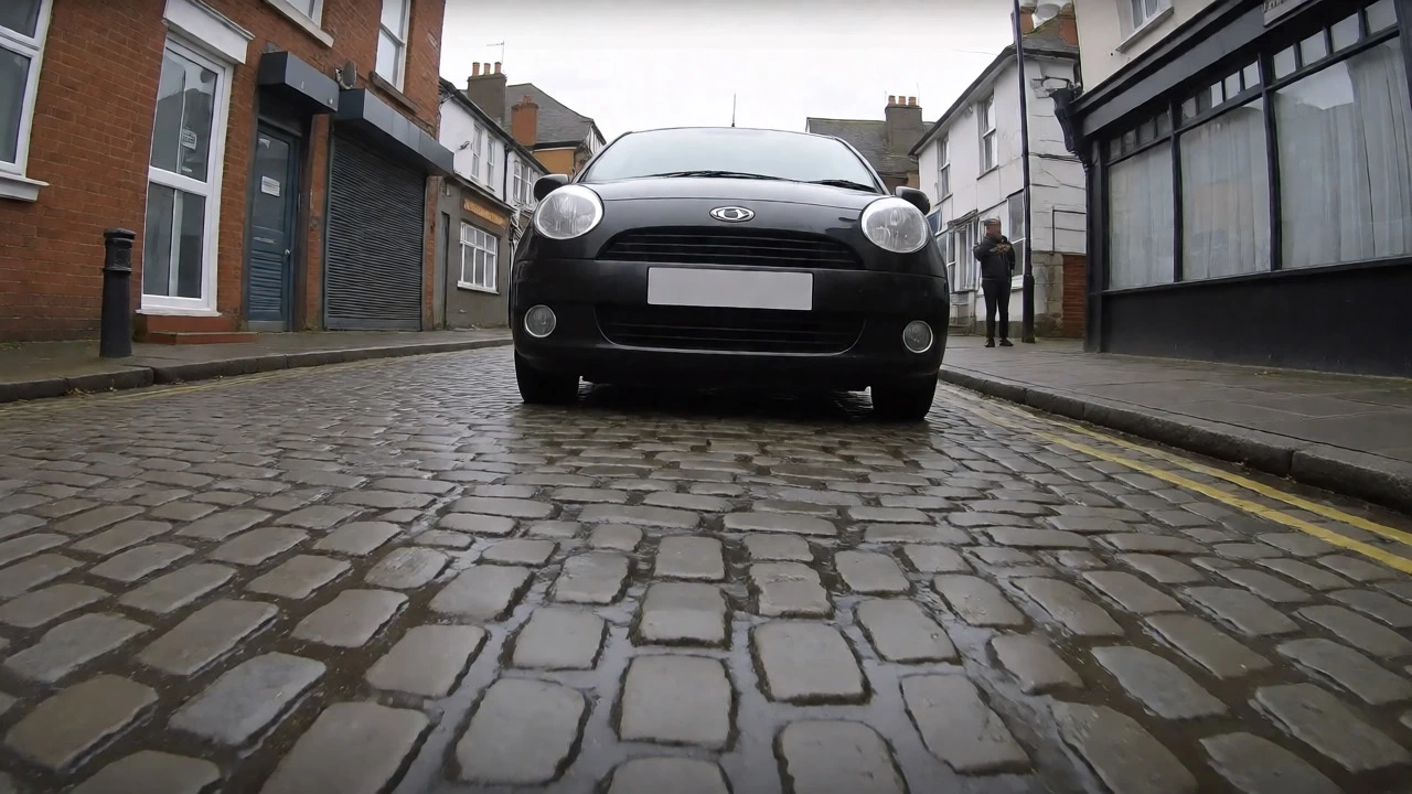 Car driving over bumps on a cobblestone street to test suspension